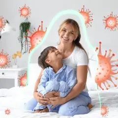 Mama tuli dziecko, które miało kaszel w nocy. Wokół nich wirusy, ale chroni je zielona bariera.