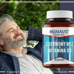 Szczęśliwy mężczyzna zrelaksowany na łonie natury, obok butelka suplementu diety z wyciągiem z czerwonego ryżu i witaminą D3.