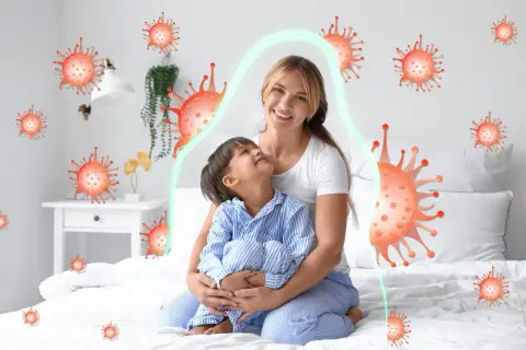 Mama tuli dziecko, które miało kaszel w nocy. Wokół nich wirusy, ale chroni je zielona bariera.